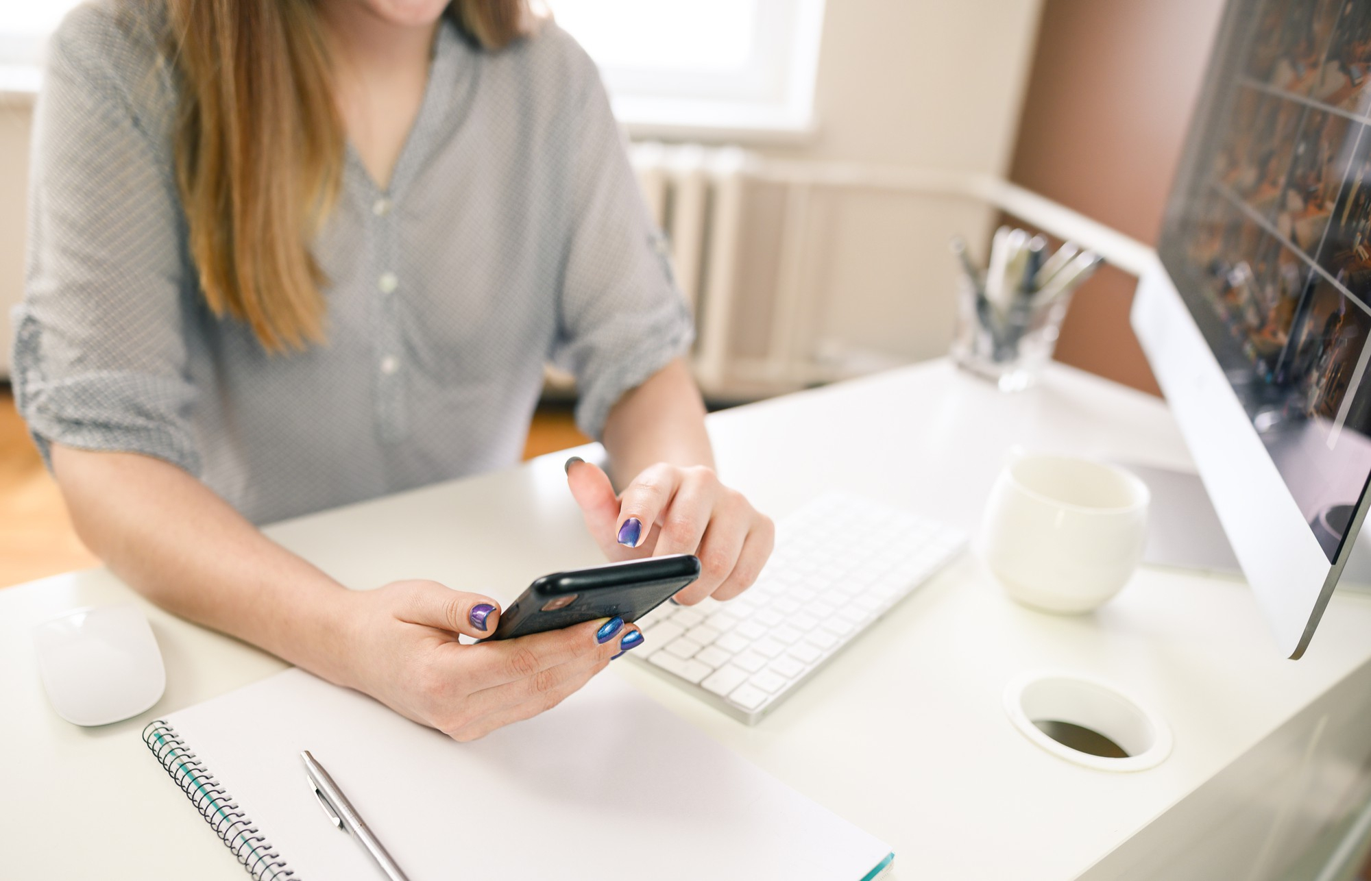 Visitor using a phone at a desk to take the next step with a local business