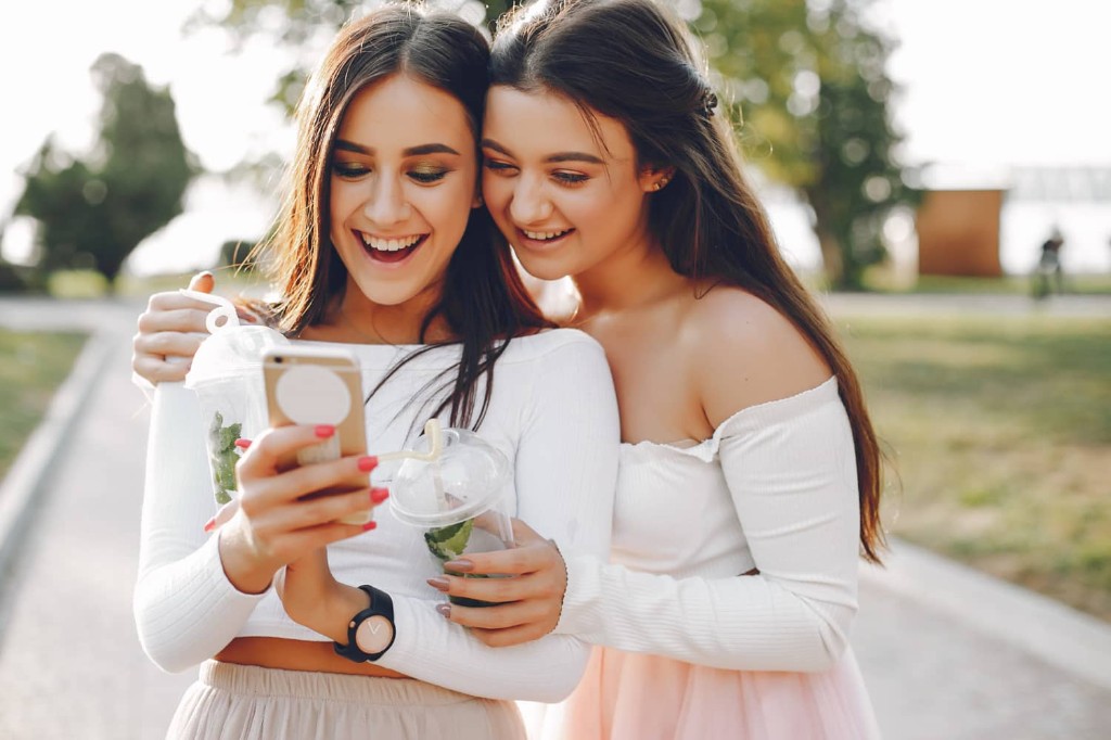 Happy customers engaging with a business website on a phone