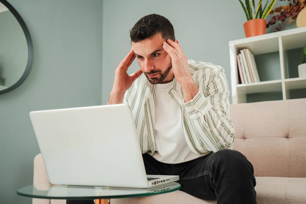 Frustrated small business owner staring at a website that is not converting visitors