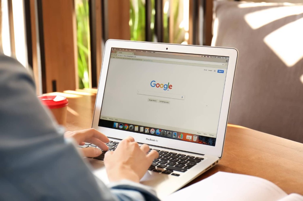 Person searching Google on a MacBook for a local business website