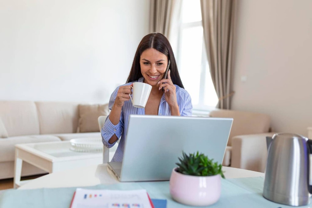 Small business owner browsing a website across laptop and phone